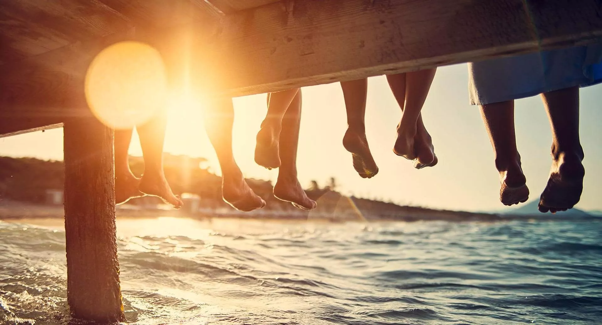 Happy couple walking in shallow water on the beach